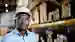 a man in a warehouse with text on his face showing his thoughts